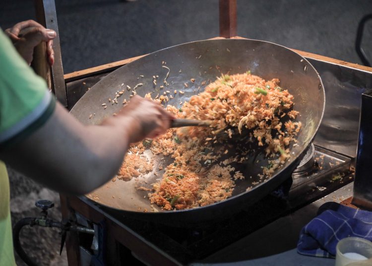 A,Man,Cooking,Fried,Rice,On,Steel,Skillet,Pan,For