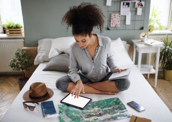 Young,Woman,With,Tablet,And,Map,Indoors,At,Home,,Planning