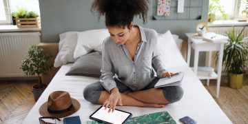 Young,Woman,With,Tablet,And,Map,Indoors,At,Home,,Planning