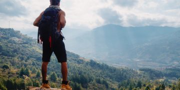 Young,Man,With,Long,Hair,Without,Shirt,And,Big,Backpack