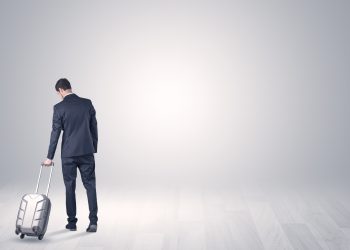 Young,Businessman,In,A,White,Boundless,Space,Walking,With,Back