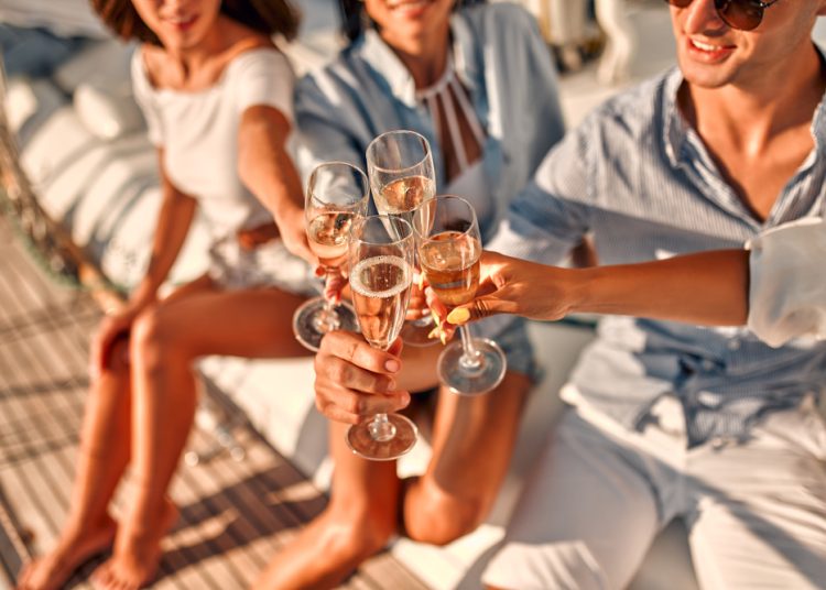 Cheers!,Cropped,Image,Of,Group,Of,Friends,Relaxing,On,Luxury